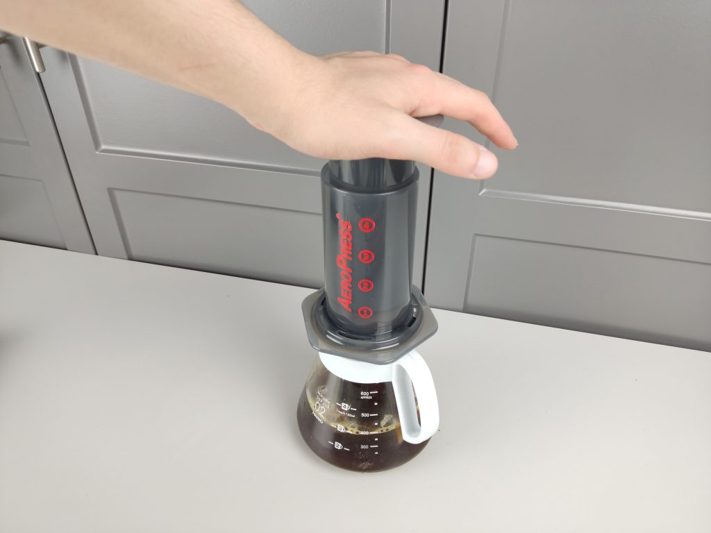 pressing the plunger of aeropress