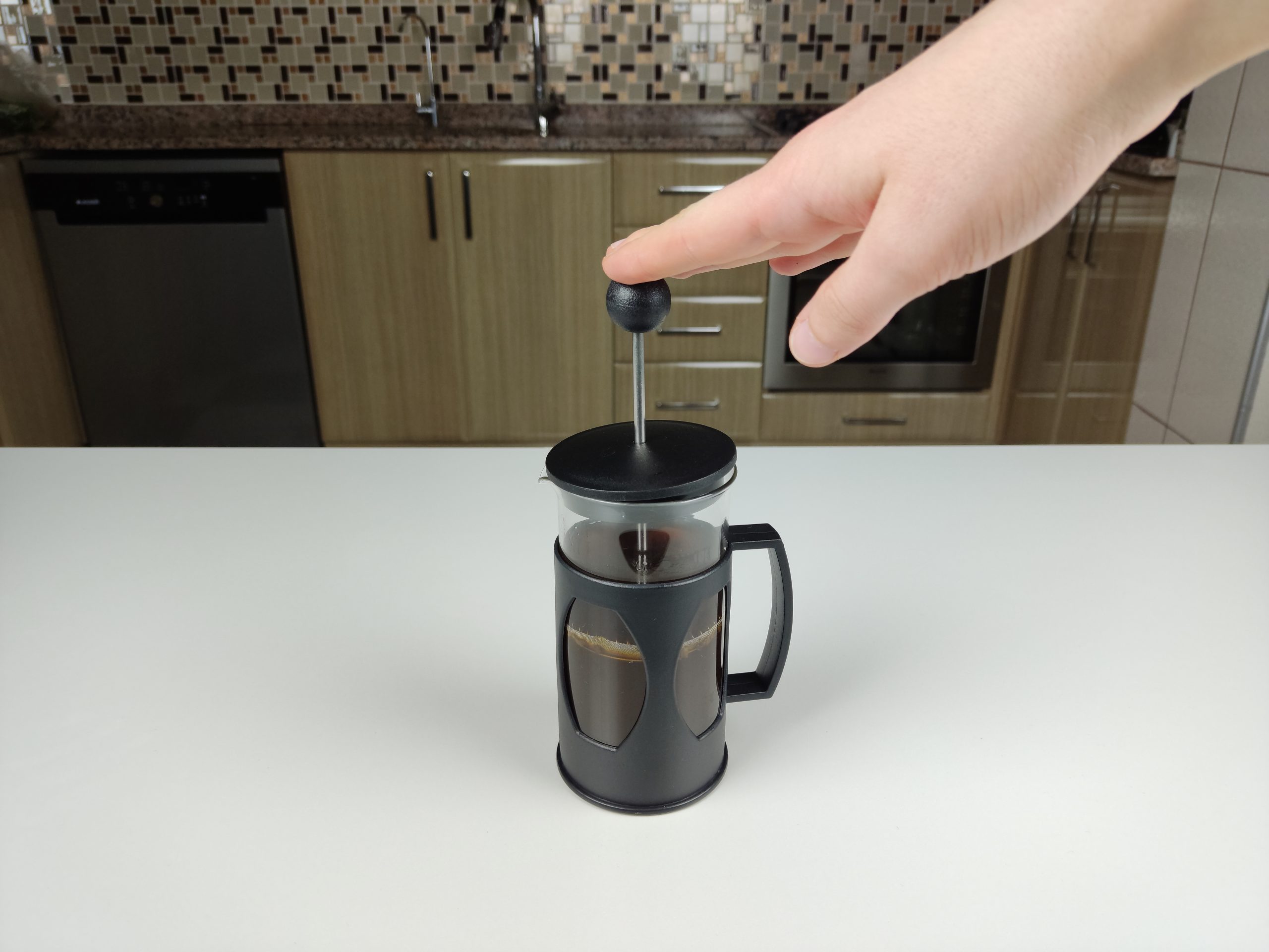 pressing the plunger of french press