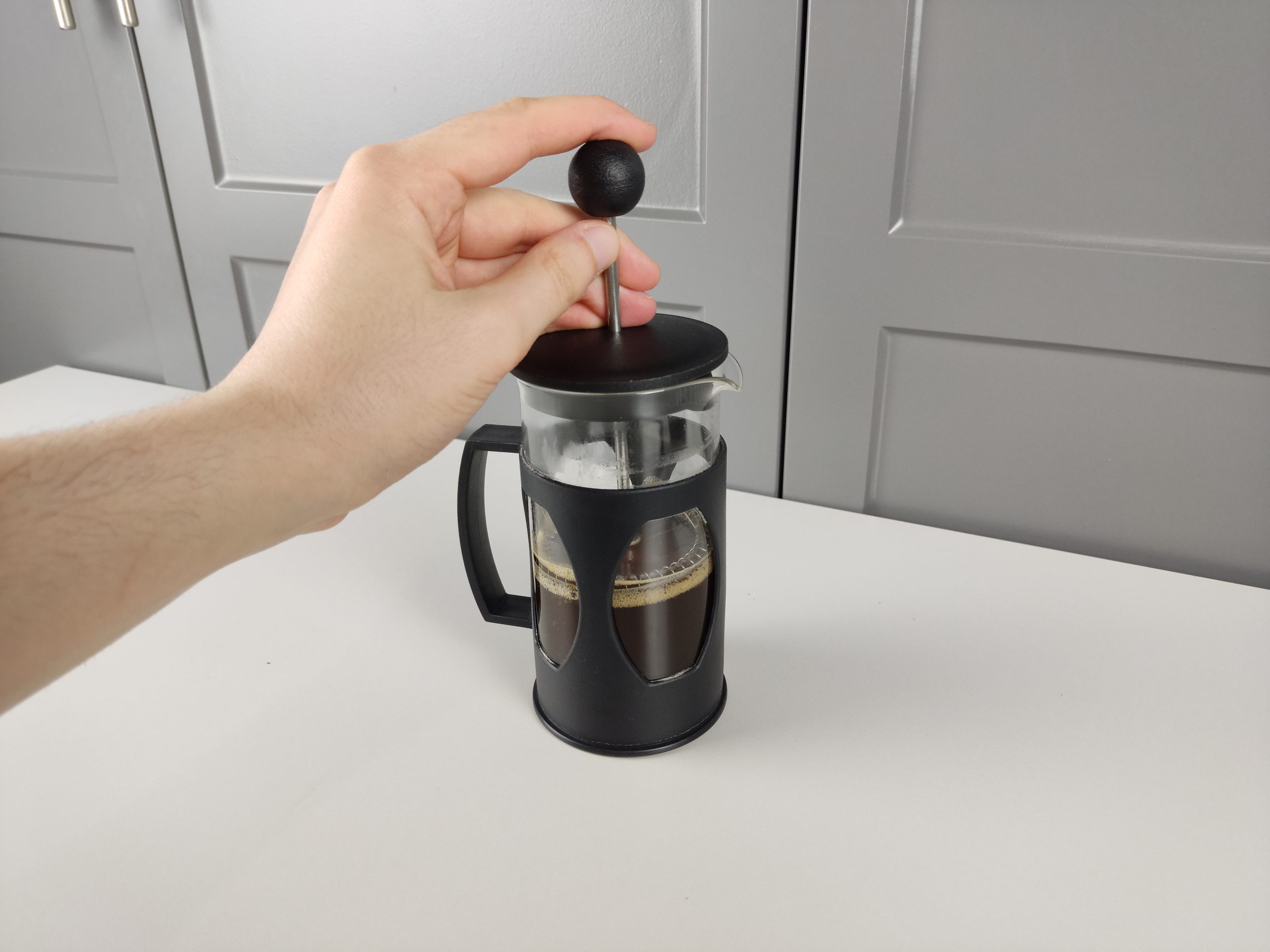 Pressing the plunger of French press