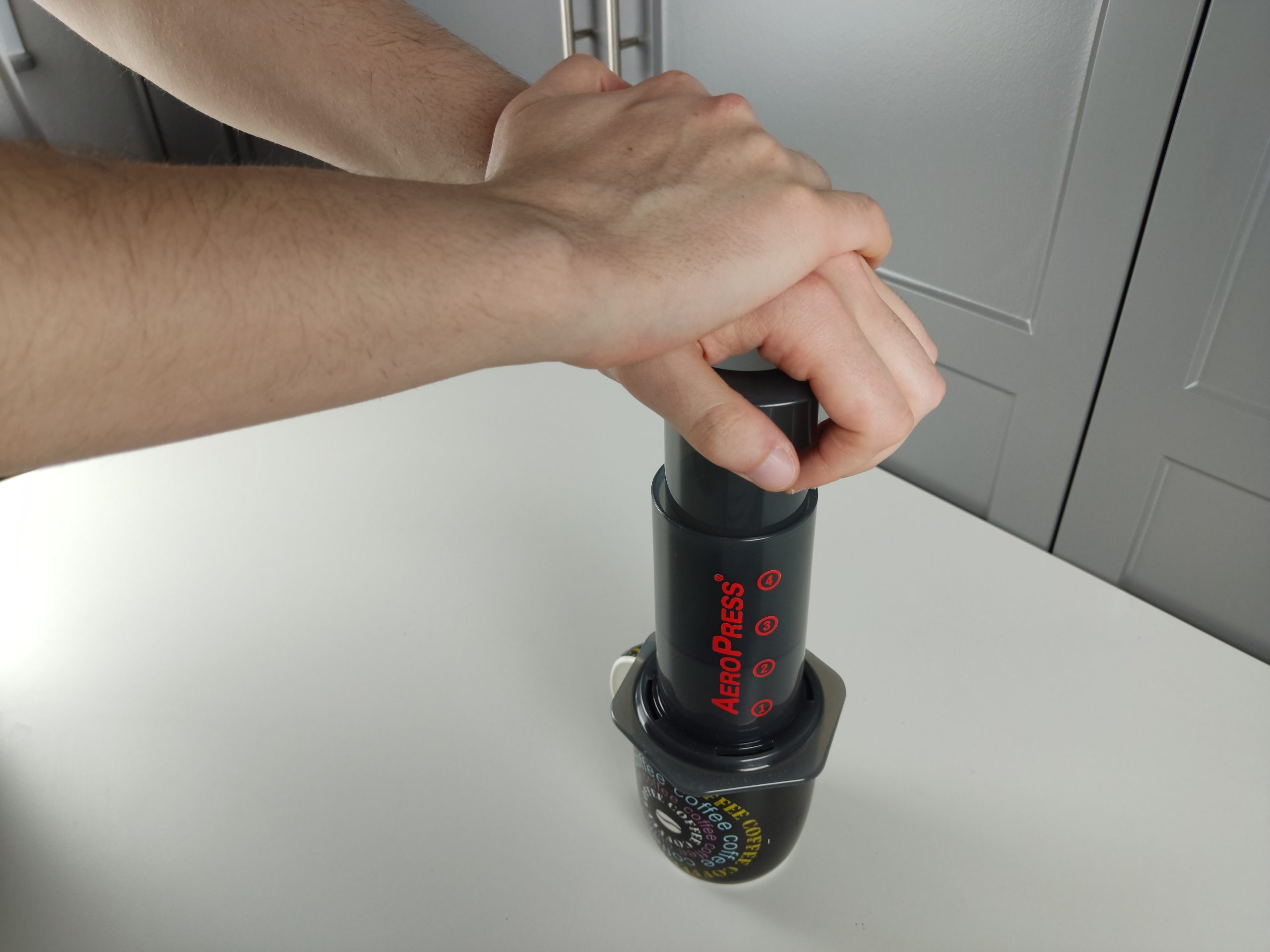 pressing the plunger of aeropress