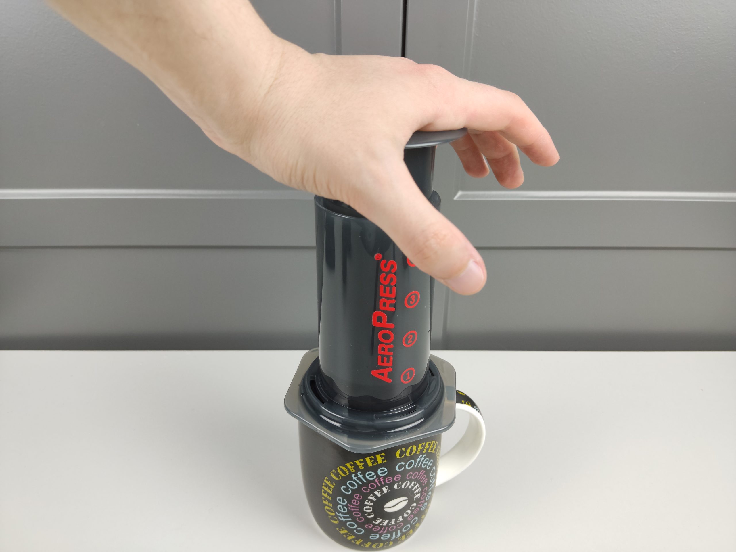 pressing the plunger of aeropress